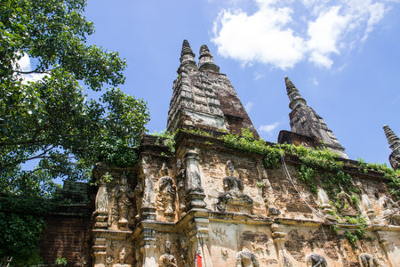 the buddha and angel sculpture on ancient pagoda in northern thailandの写真素材