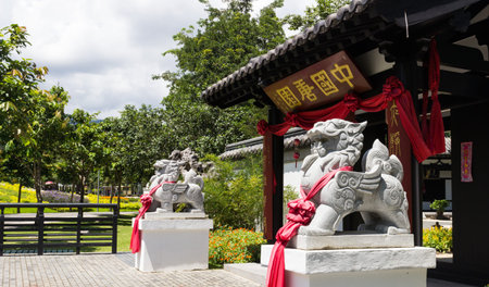 the chinese style lion statue in front of the buildingのeditorial素材