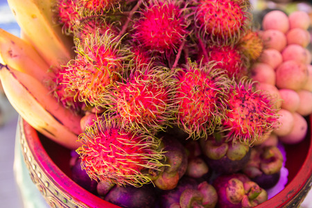 rambutan,banana , mangosteen and Lanzones in a bowlの写真素材