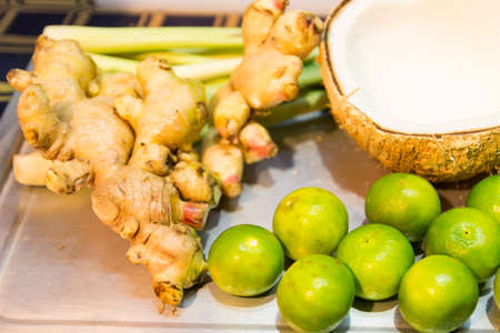 ginger, lemon ,lemongrass  and coconut which are the ingredient for thailand traditional sweet snack called miangkumの写真素材