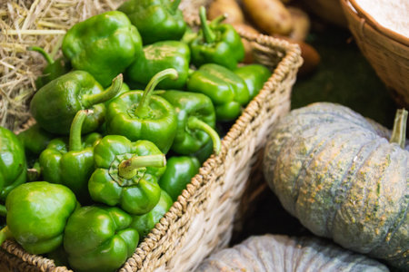 stack of green sweet bell pepper in the basketの写真素材