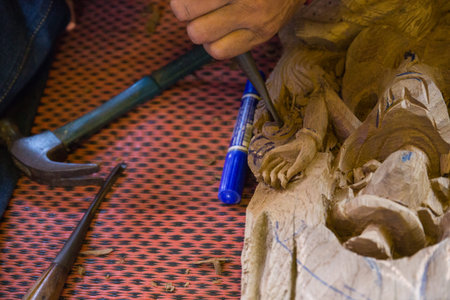 CHIANGMAI, SEPTEMBER 21: the view of the craftsman's hand using the chisel to engrave thailand...