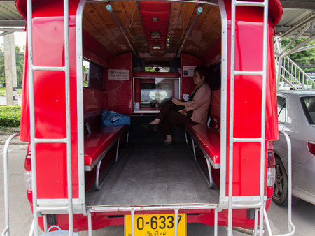 CHIANGMAI, SEPTEMBER 23: The asian tourist on the red minibus which is the main transportation service for travelling in Chiangmai, Thailand on September 23, 2014.のeditorial素材