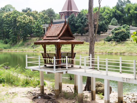 the walkway to the thailand traditional wooden pavilion beside the pondのeditorial素材