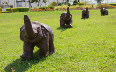 the decorative baby elephant figurine on the lawn yardの写真素材