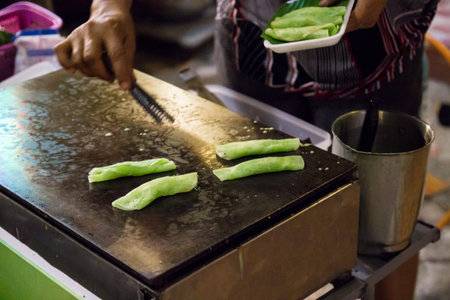 thailand traditional snack sweet soft rolled wafer grilling on the stoveの写真素材