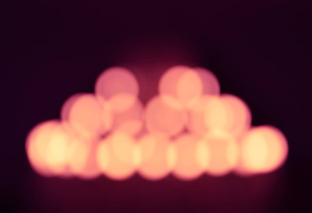 the blurry defocused image of yellow lighting from chandelier with orange highlight and purple shadowの写真素材