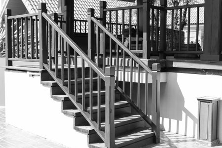 shadow of the bannister on wooden stair step