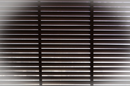 lighting thru horizontal sun blind or sunshade with vignette for backgroundの写真素材