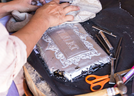 Chiangmai, Thailand - November 4, 2014: The silversmith using the graver to engrave art tracery on silverware at Srisuphan temple in Muang district in Chiangmai province.のeditorial素材