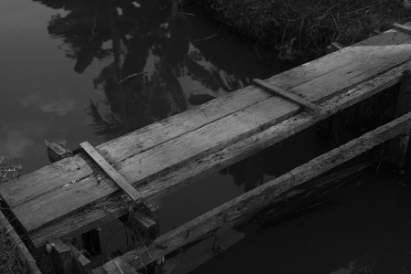 small old wooden bridge across the canalの写真素材