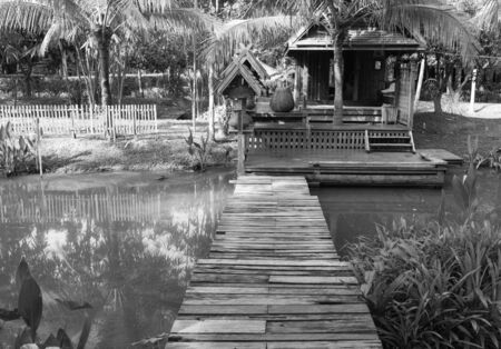 the design of thailand traditional vintage wooden house beside the canalのeditorial素材
