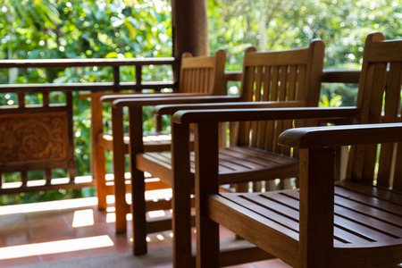 wooden chair on the balcony near the gardenの写真素材