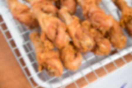 blurry image of many pieces of fried chicken thigh on the sieveの写真素材