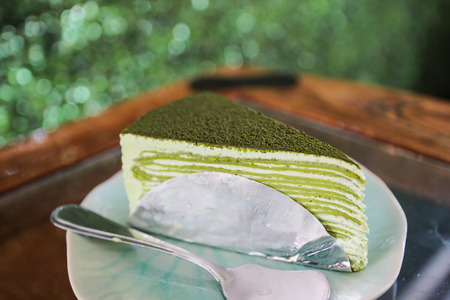 green tea crepe cake on green dishの写真素材
