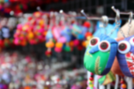 blurry image of colorful handmade souvenir key chain selling at the marketの写真素材
