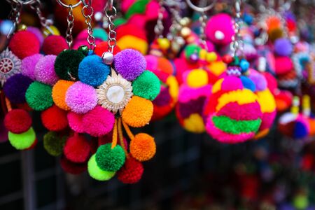 colorful handmade souvenir key chain selling at the marketの写真素材