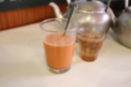 blurry image of glasses of thailand and chinese tea and traditional old kettleの写真素材