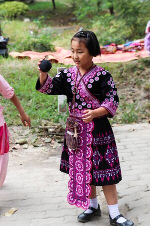 Chiangmai, Thailand - December 18, 2014: thailand hill tribe girl with traditional northern tribe costume in royal project fair at Chiangmai university.のeditorial素材