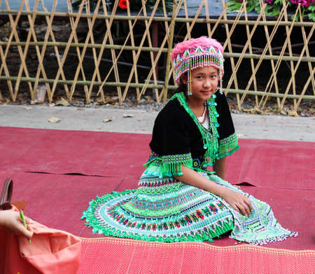 Chiangmai, Thailand - December 18, 2014: Thailand hill tribe girl with traditional northern tribe costume in royal project fair at Chiangmai university.のeditorial素材