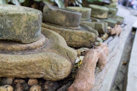 antique millstone decorating in the gardenの写真素材
