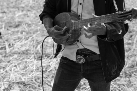Thailand traditional musician hillbilly playing country folk music in rice paddy field, black and whiteの写真素材