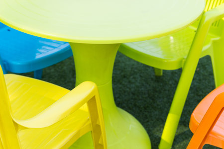 yellow, orange, green, blue plastic desk and chairの写真素材