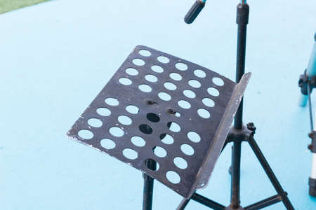 black metal music stand on blue floorの写真素材