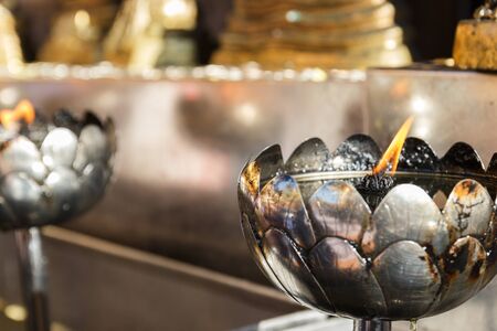 candle light in silver lotus candlestick in templeの写真素材