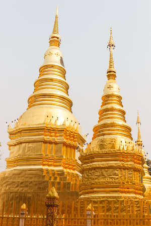 golden buddhist pagoda in temple in northern part of Thailandの写真素材