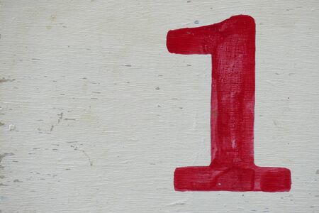 number one painted in red on white wooden boardの写真素材