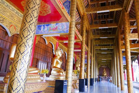 row of golden buddha statue in monastery in  thailandのeditorial素材