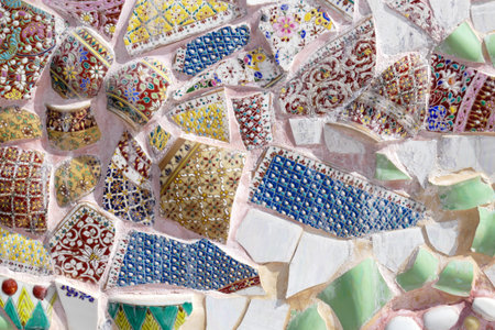 the art design of the colorful broken tile and thailand traditional bowl decorating on temple wall...