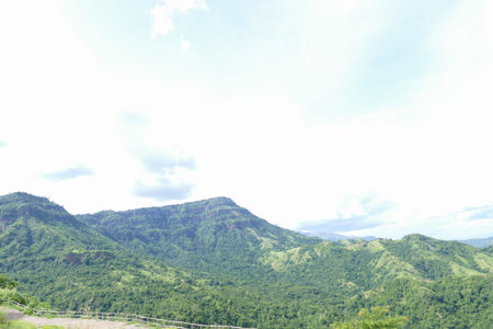 view of mountain landscape with forest and meadow in countryside of thailand