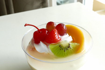 vanilla pudding mousse topping with strawberry, mango, cherry, kiwi and grapeの写真素材
