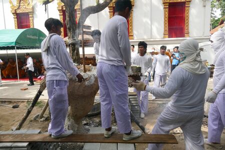 Chiang Mai, Thailand -  July 8, 2015: The man is pouring melting metal in furnace for casting buddha statue in Suntidham temple on July 8, 20.15 in Chiang Mai, Thailand.のeditorial素材