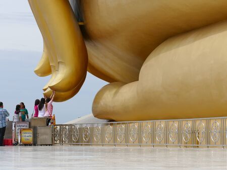 Ang Thong, Thailand - August 1, 2015: buddhist people touch the finger of big golden buddha statue in Muang temple.のeditorial素材