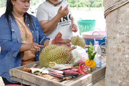 Prachuap Khiri Khan, Thailand - July 29, 2015: The woman is peeling durian for the customer at the marketのeditorial素材