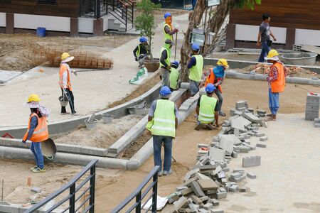 Chiang Mai, Thailand - July 25, 2015: The workers are constructing pathway at the construction site in Nirotharam temple.のeditorial素材