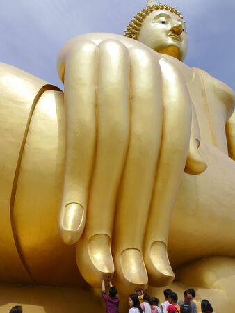 Ang Thong, Thailand - August 1, 2015: buddhist people touch the finger of big golden buddha statue in Muang temple.のeditorial素材