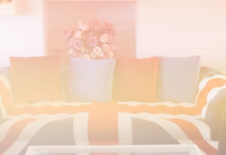 sofa with british flag cushion, pillow and bouquet of roses for decoration (color filter and soft focus)の写真素材