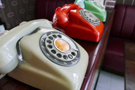 old beige, red, green dialling telephone for vintage style decoration