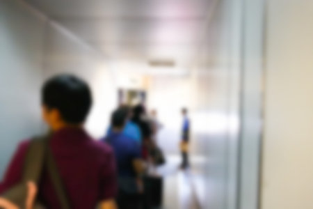 blurry defocused image of people in the aerobridge at the airport