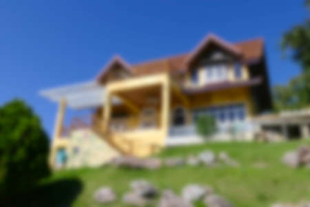 blurry defocused image of yellow house on the hillの写真素材