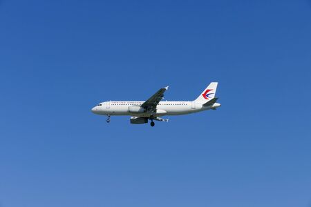 Chiang Mai, Thailand - December 1, 2015: The airplane of China Eastern Airlines is flying in blue sky in Chiang Mai, Thailand on December 1, 2015.のeditorial素材