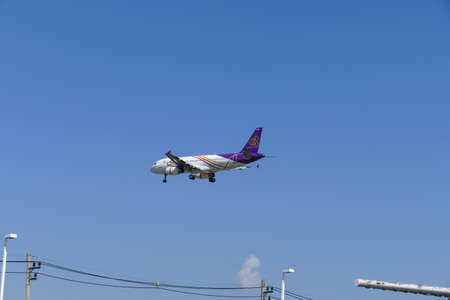 Chiang Mai, Thailand - December 1, 2015: The airplane of Thai Smile Air is flying in blue sky in Chiang Mai, Thailand on December 1, 2015.のeditorial素材