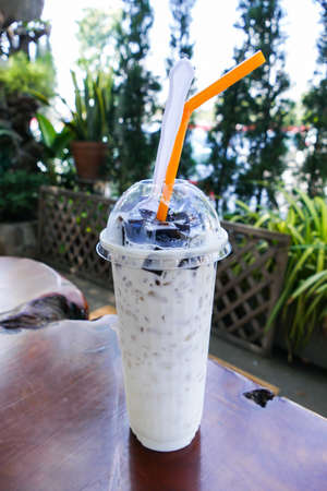 chinese vegetable black jelly with milk and ice in a cupの写真素材