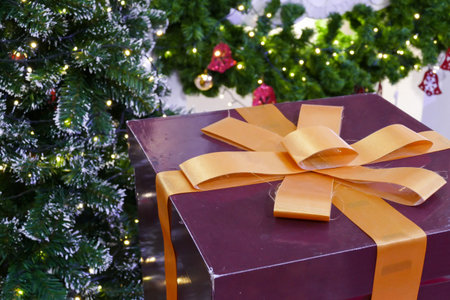 gift box present with ribbon and christmas tree for christmas and new year concept