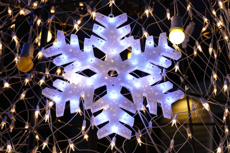 light of snowflake decorating on christmas treeの写真素材