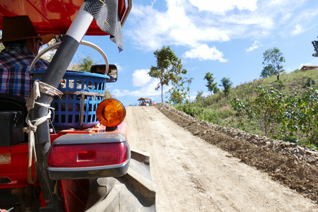Phayao, Thailand - December 31, 2015: tourist on rickshaw travel in sunflower field on the mountain at Mon Tantawan Phayao, Thailand on December 31, 2015.のeditorial素材